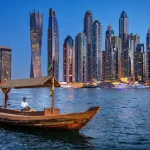 Dubai Marina skyline at blue hour with abra boat — Dubai trip cost guide 2026