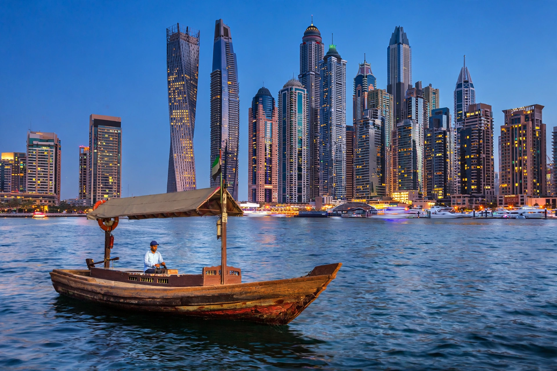 Dubai Marina skyline at blue hour with abra boat — Dubai trip cost guide 2026