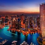 Dubai skyline at sunset with high-rise towers glowing in golden light