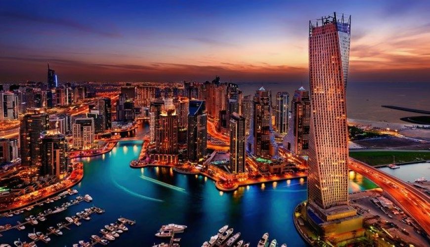 Dubai skyline at sunset with high-rise towers glowing in golden light