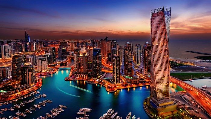 Dubai skyline at sunset with high-rise towers glowing in golden light