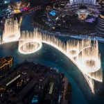 Dubai Fountain show at night with Burj Khalifa rising behind the lake