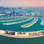 Aerial view of Palm Jumeirah, Dubai, with the Dubai Marina skyline in the distance