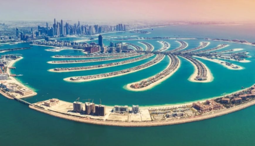Aerial view of Palm Jumeirah, Dubai, with the Dubai Marina skyline in the distance