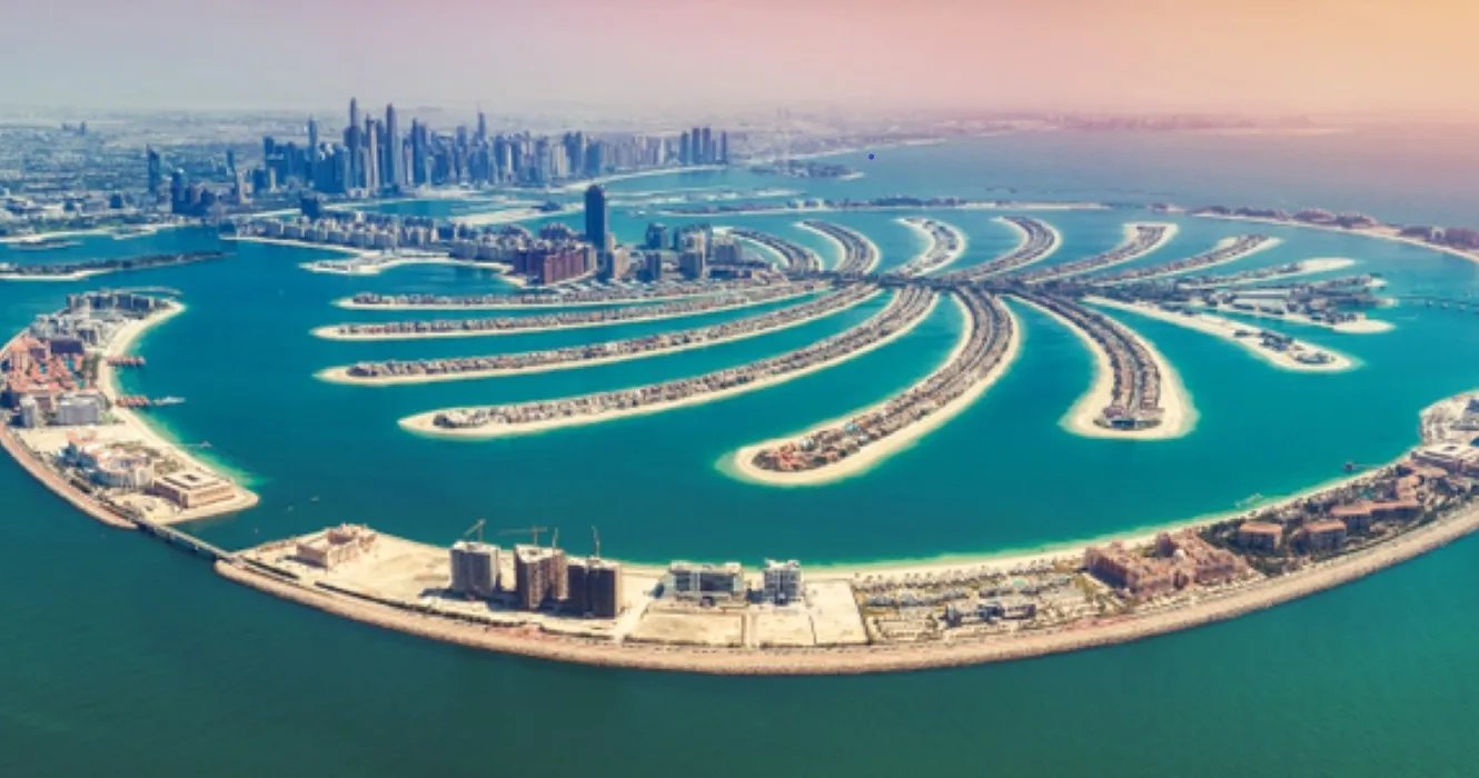 Aerial view of Palm Jumeirah, Dubai, with the Dubai Marina skyline in the distance