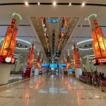 Dubai International Airport at night, with hotels nearby for layovers and early flights