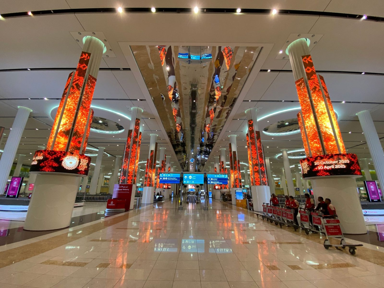 Dubai International Airport at night, with hotels nearby for layovers and early flights