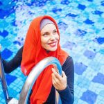 Woman in a burkini at a swimming pool