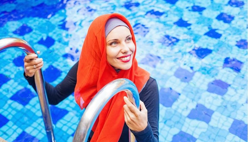 Woman in a burkini at a swimming pool