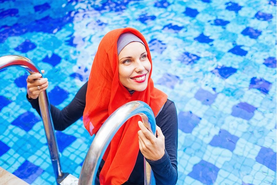 Woman in a burkini at a swimming pool