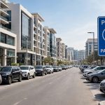Cars parked along a Dubai street with a Parkin paid parking sign