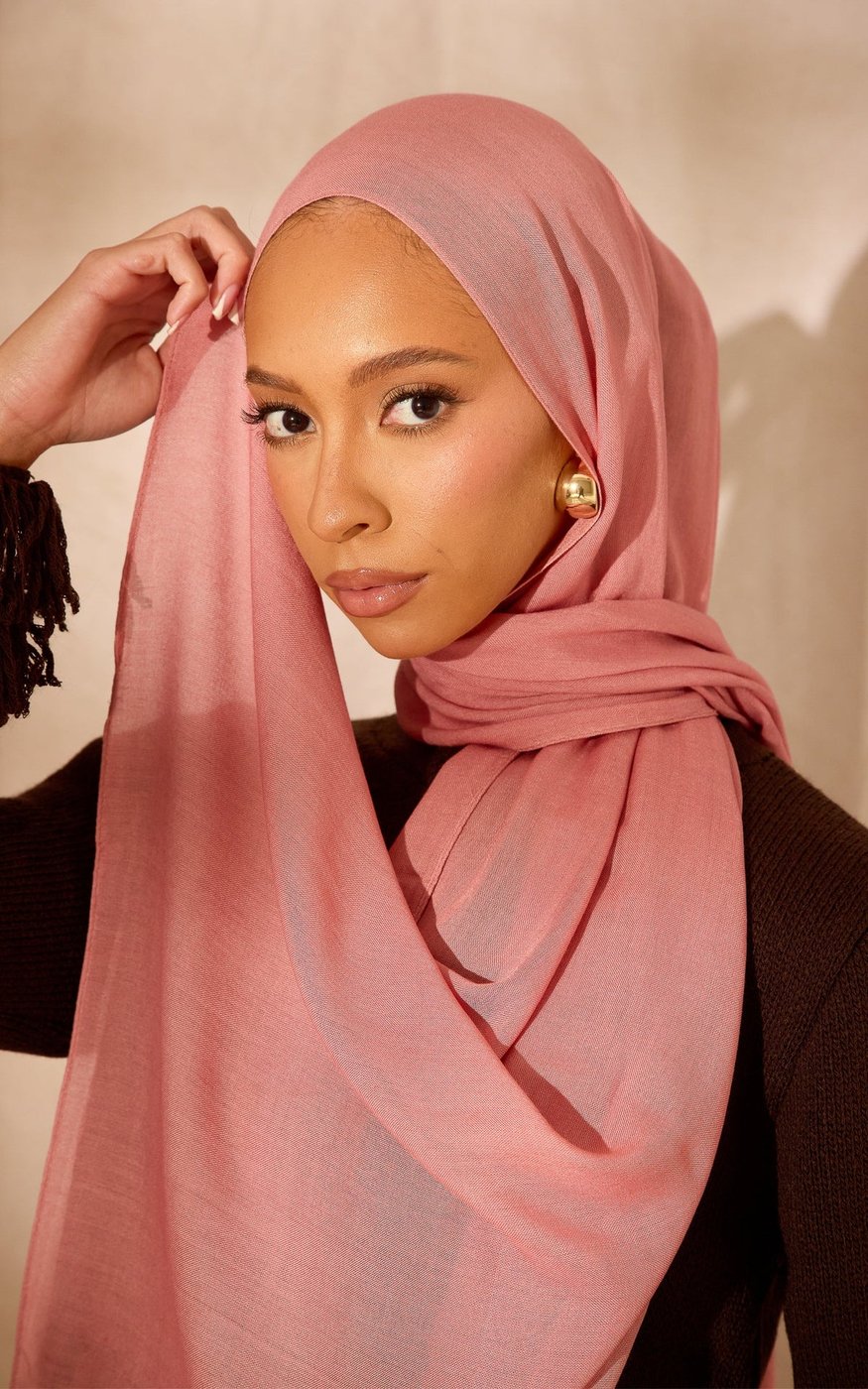 A modal hijab scarf in a soft rose shade, showing its smooth lightweight weave