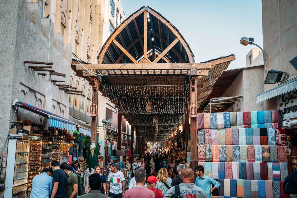 A busy traditional souk street in Deira with market stalls