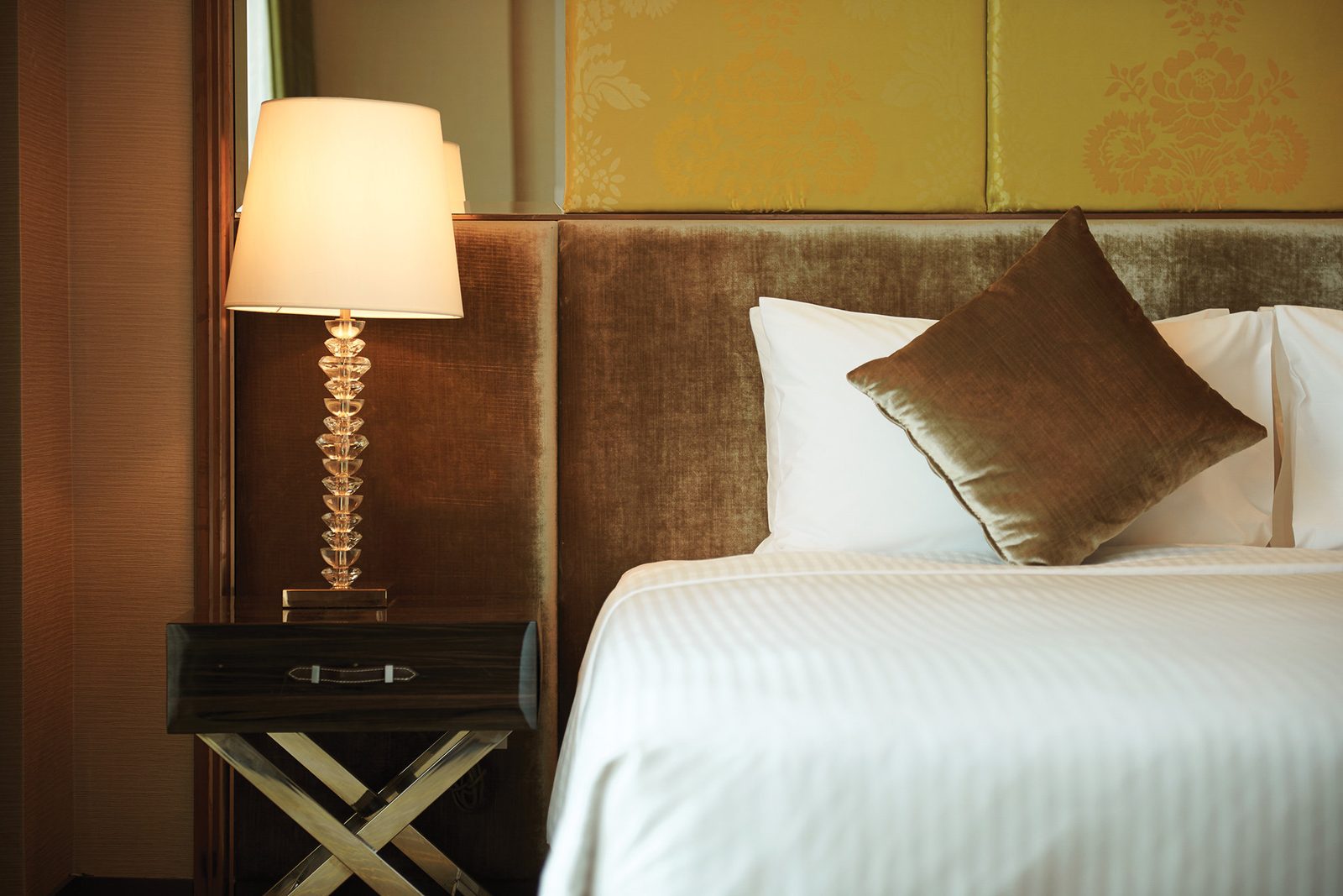 Comfortable hotel bedroom with bedside lamp near Dubai airport