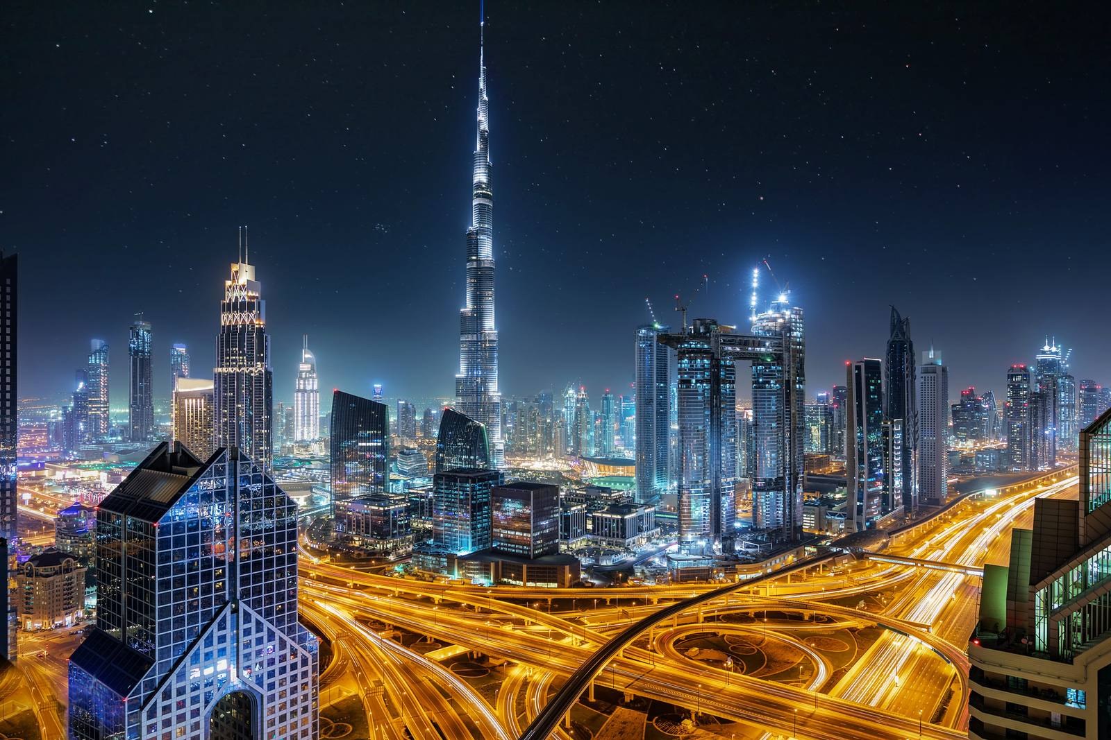 Downtown Dubai skyline glowing at night with Burj Khalifa above the city lights