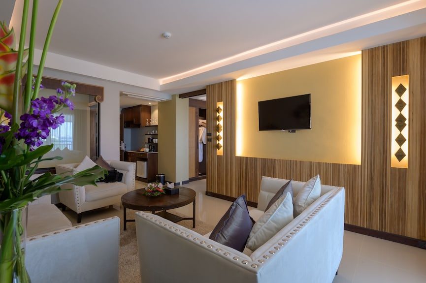 Spacious family hotel suite living room with kitchenette and dining area