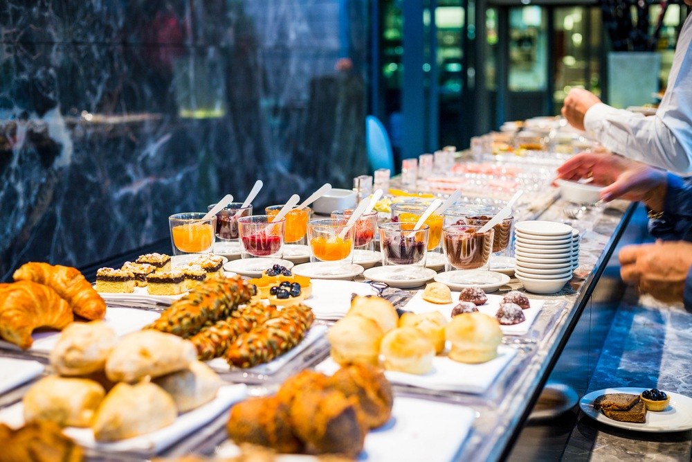 Hotel breakfast buffet with fresh pastries, breads and fruit juices