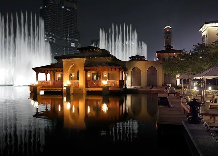 Palace Downtown hotel on the Burj Lake at night during the fountain show