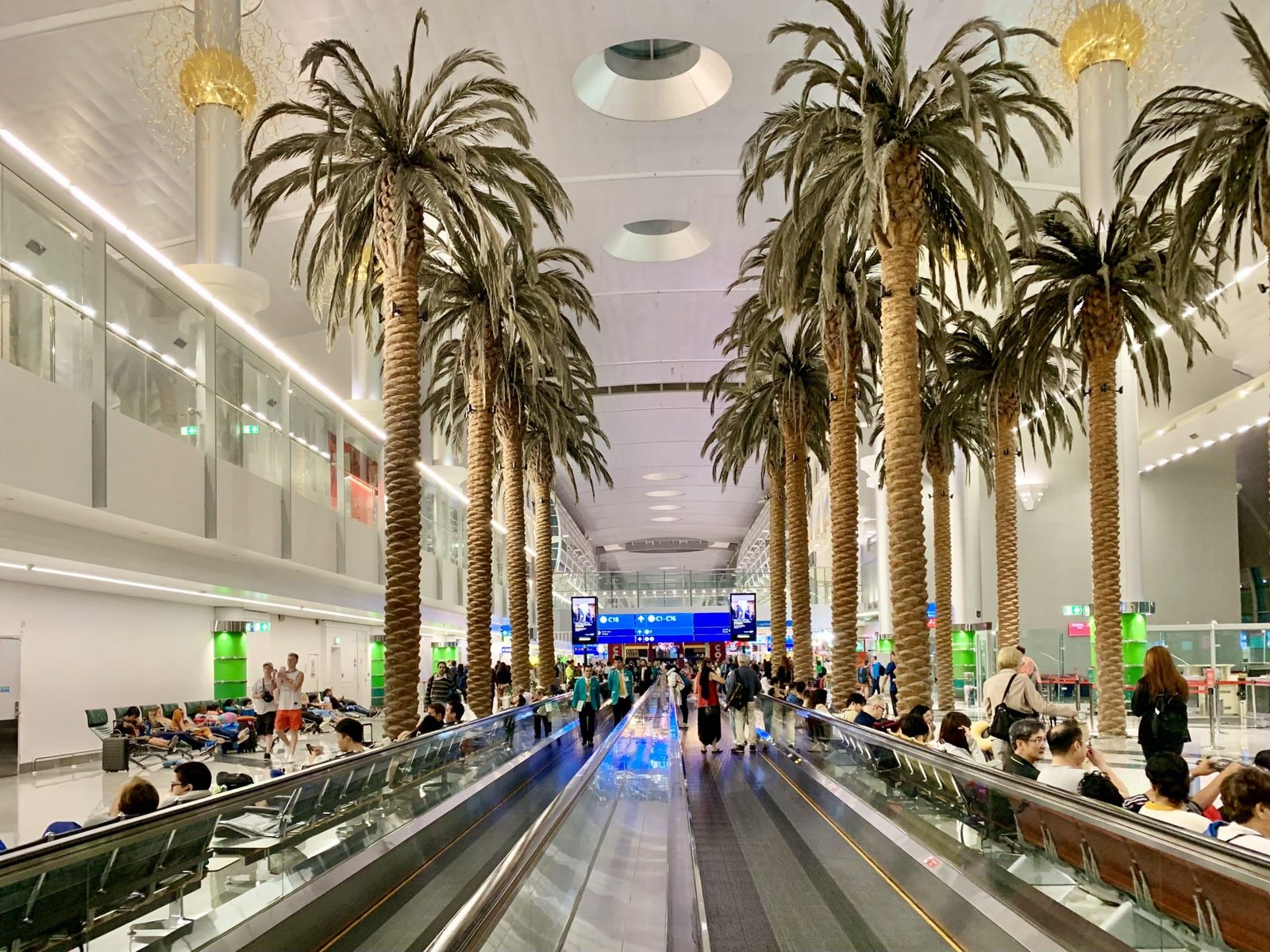 Interior of Dubai International Airport Terminal 3 with travellers at check-in