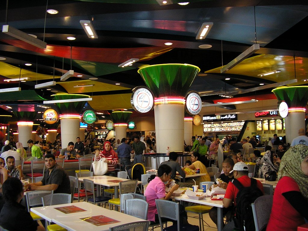 Busy food court seating area inside a Dubai shopping mall