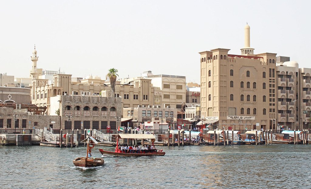 Traditional boats crossing Dubai Creek near the old souks of Deira