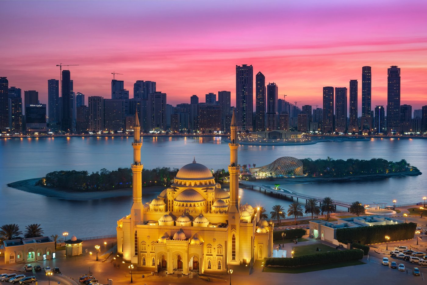 Al Noor Mosque and Al Noor Island glowing at sunset in Sharjah