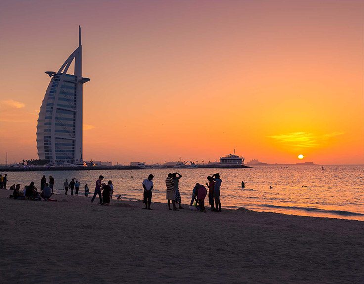 Burj Al Arab hotel by the beach at sunset