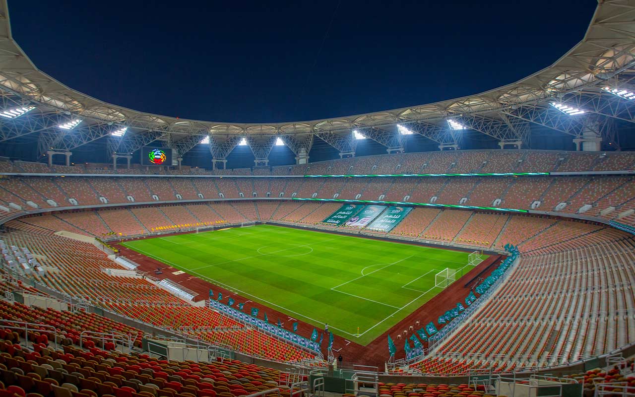 Football stadium floodlights over a packed stand before a night final