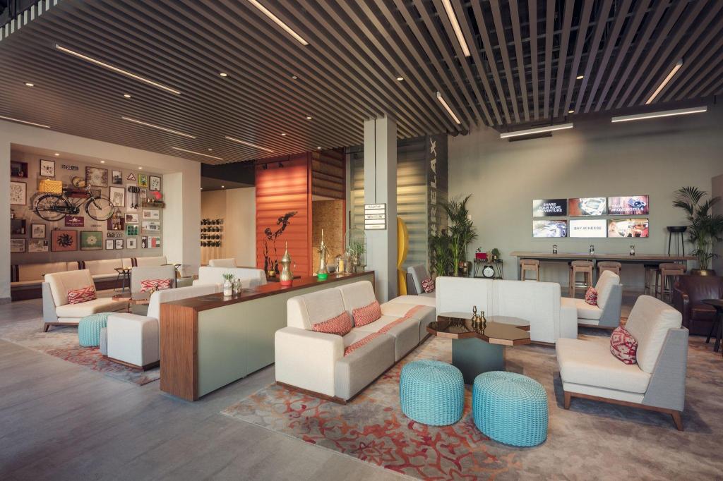Rove Downtown solo traveller working in the colourful lobby lounge