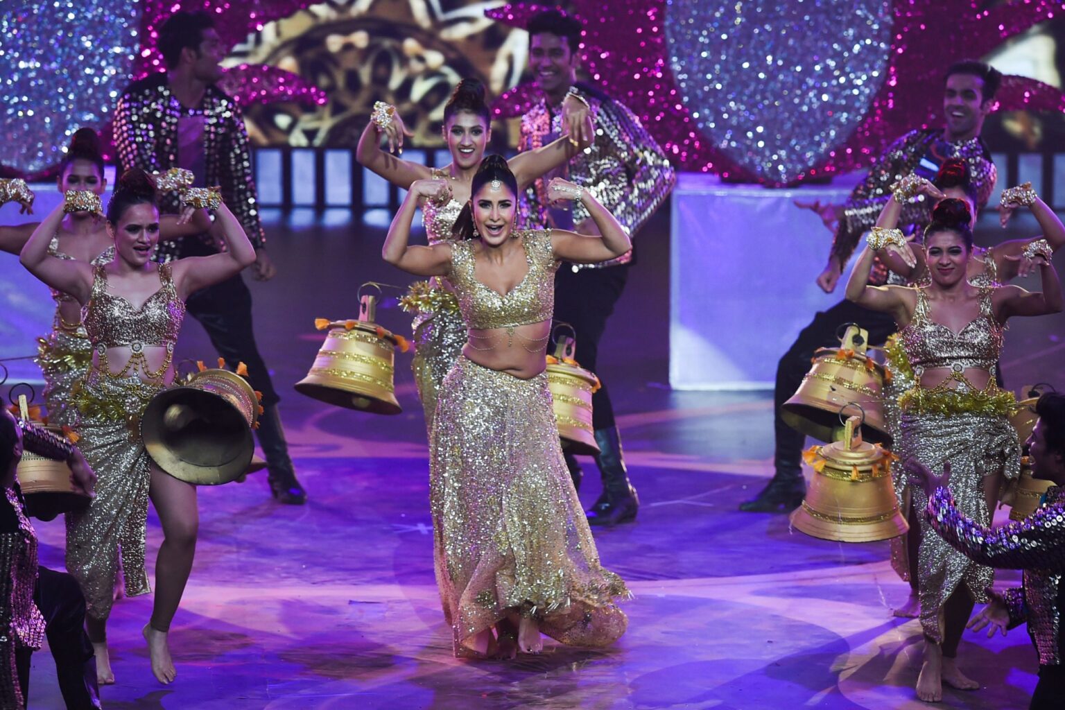 Bollywood awards ceremony stage with performers and bright lights