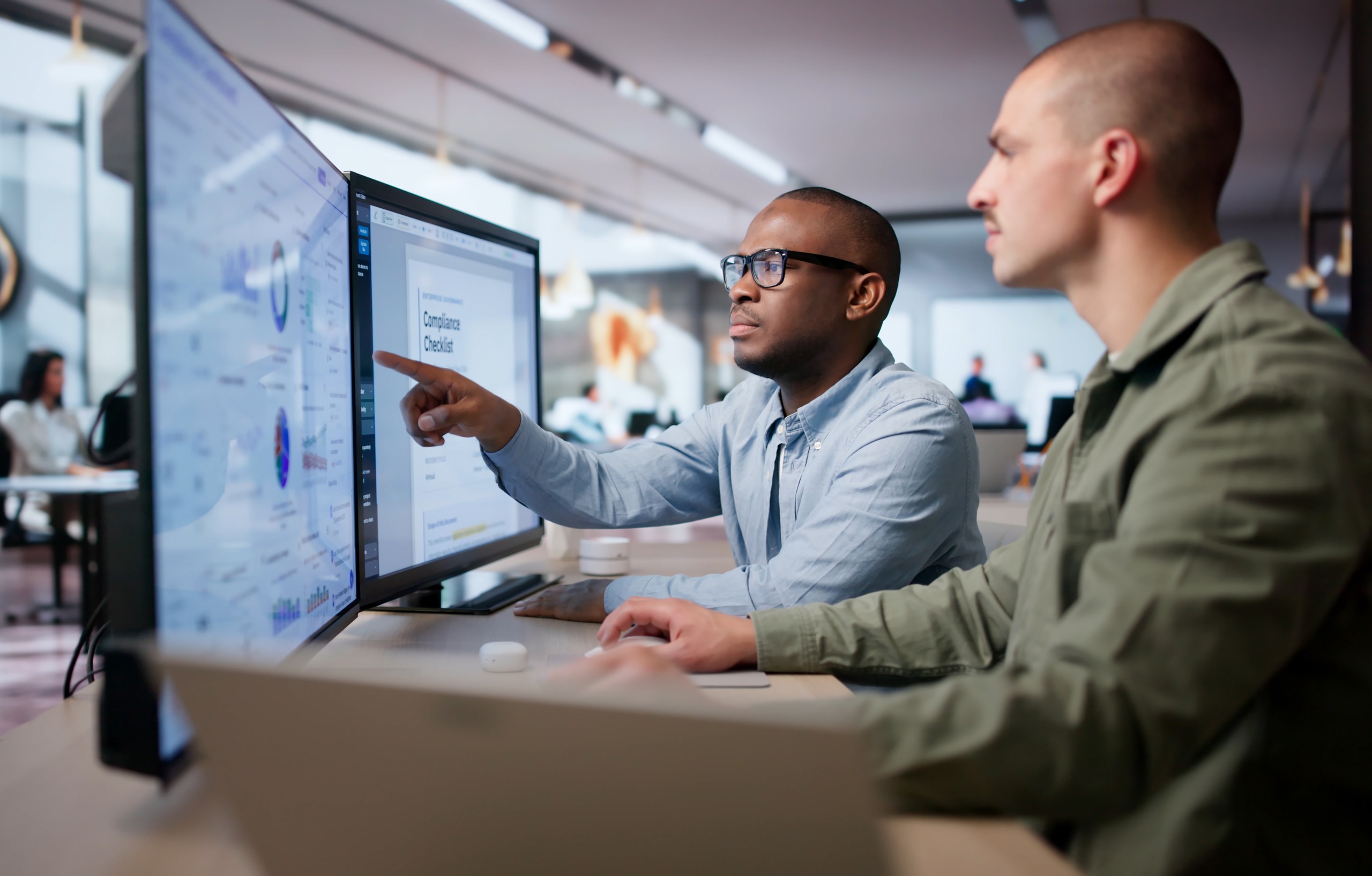 Compliance team reviewing transactions on office screens
