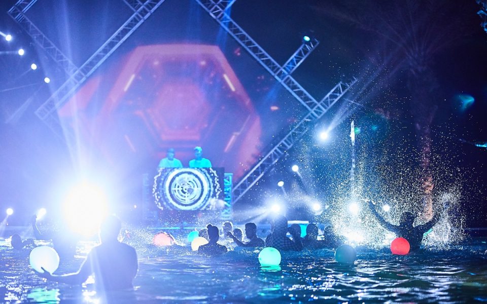 DJ stage and lights at a night-time pool party