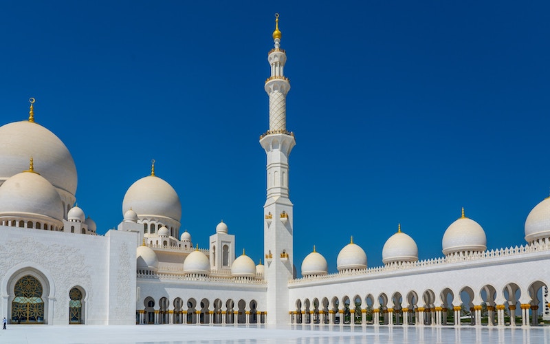 Grand mosque domes and minarets under a clear sky