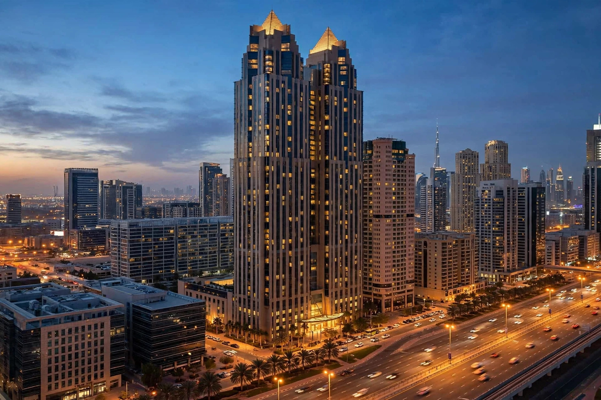 Twin towers of JW Marriott Marquis Hotel Dubai at dusk beside Sheikh Zayed Road