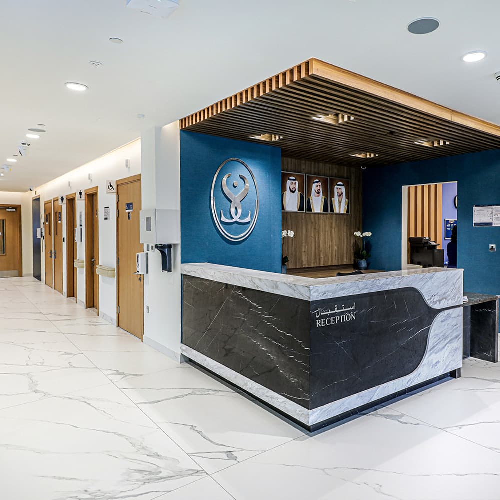 Modern hospital reception with patients and staff in Dubai