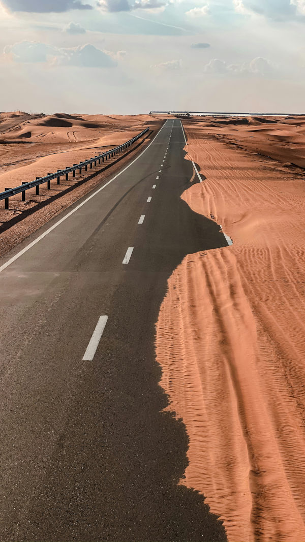Dust blowing across an inland desert road in the Emirates
