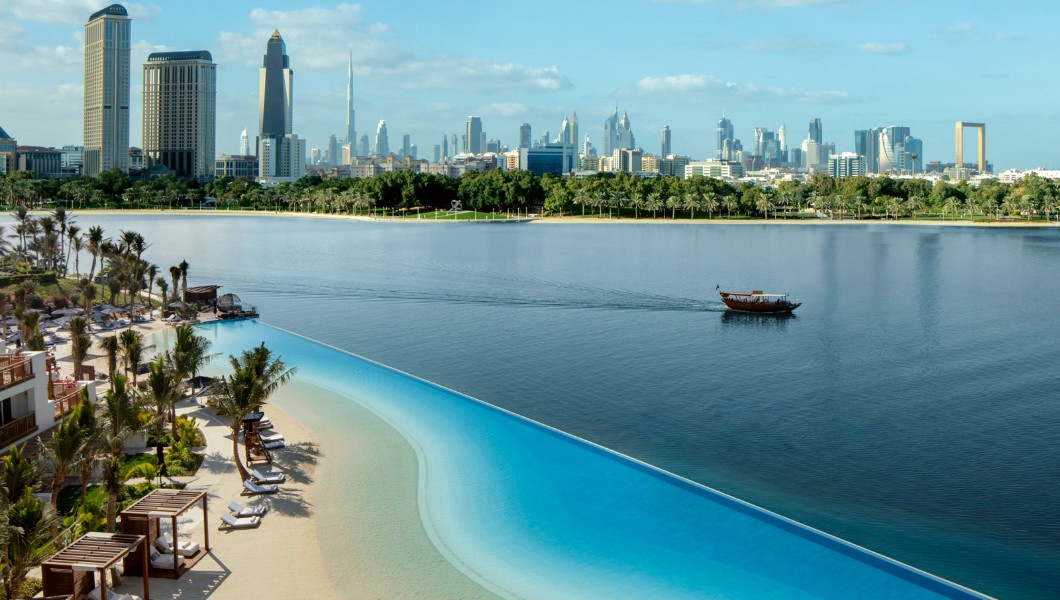 Park Hyatt Dubai lagoon pool and white buildings beside Dubai Creek