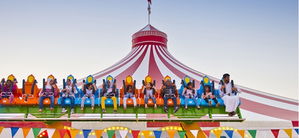 Children enjoying rides at a community park market