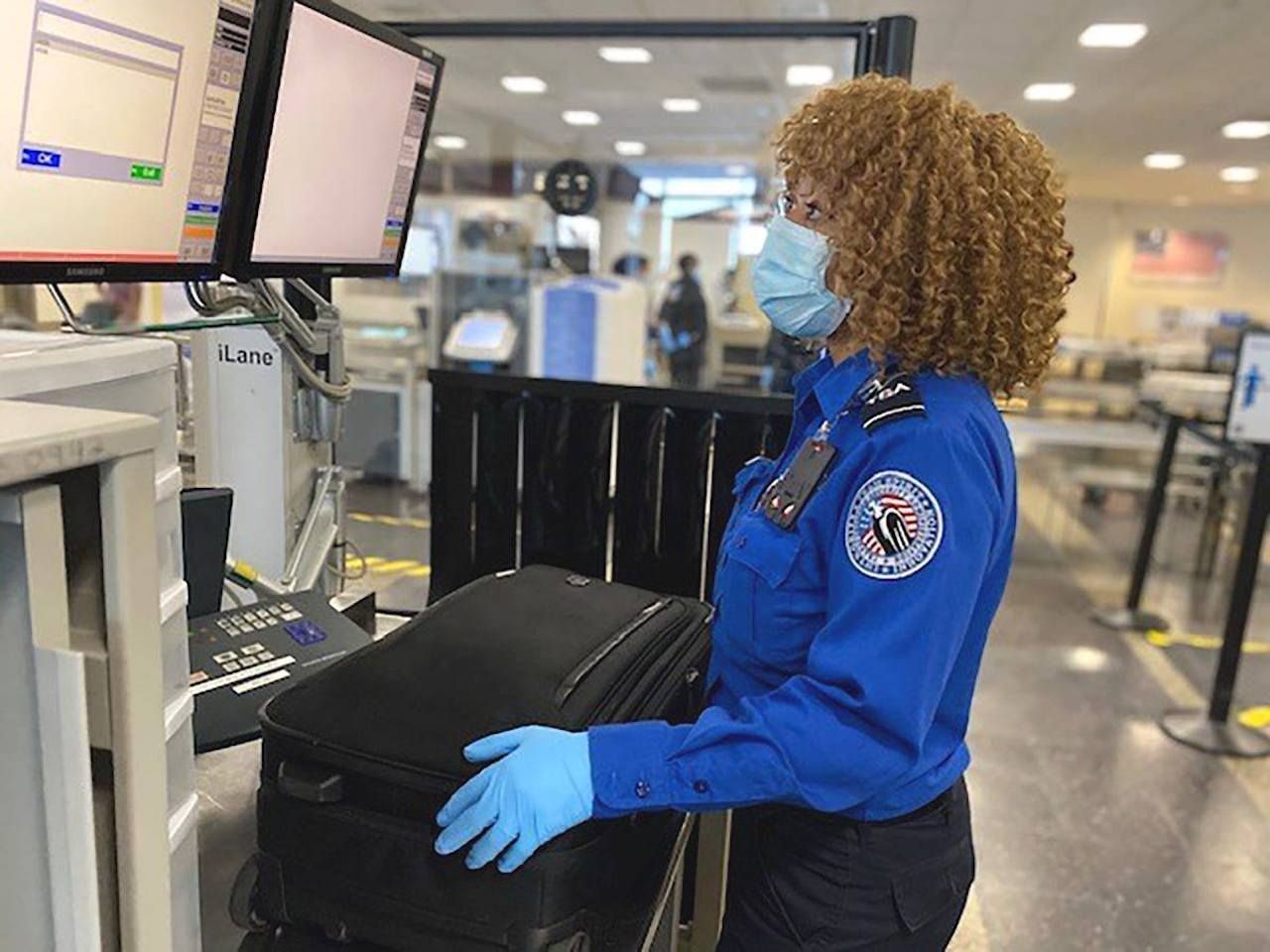 Airport staff passing through a security checkpoint