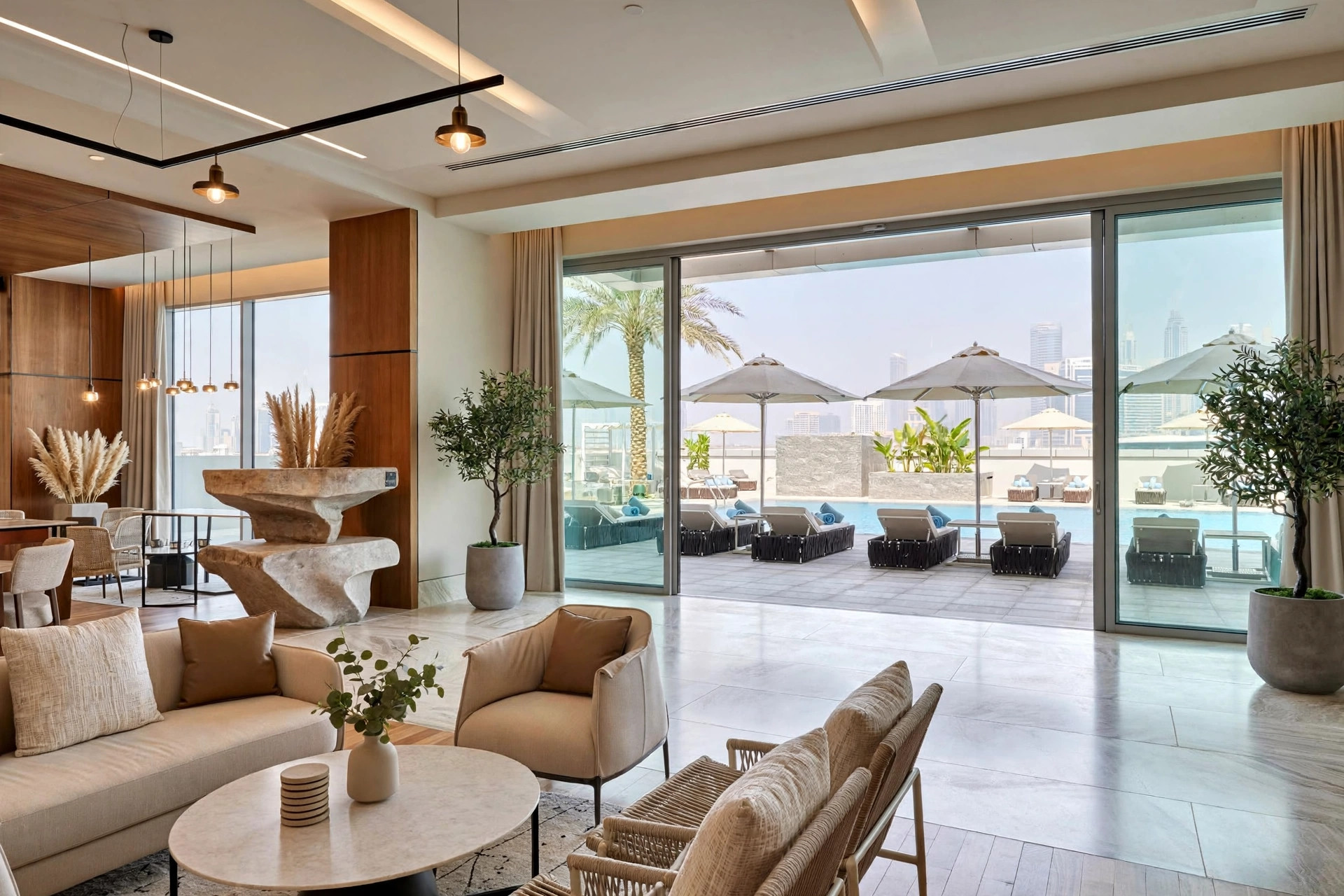 Contemporary lobby and outdoor pool at The First Collection Jumeirah Village Circle