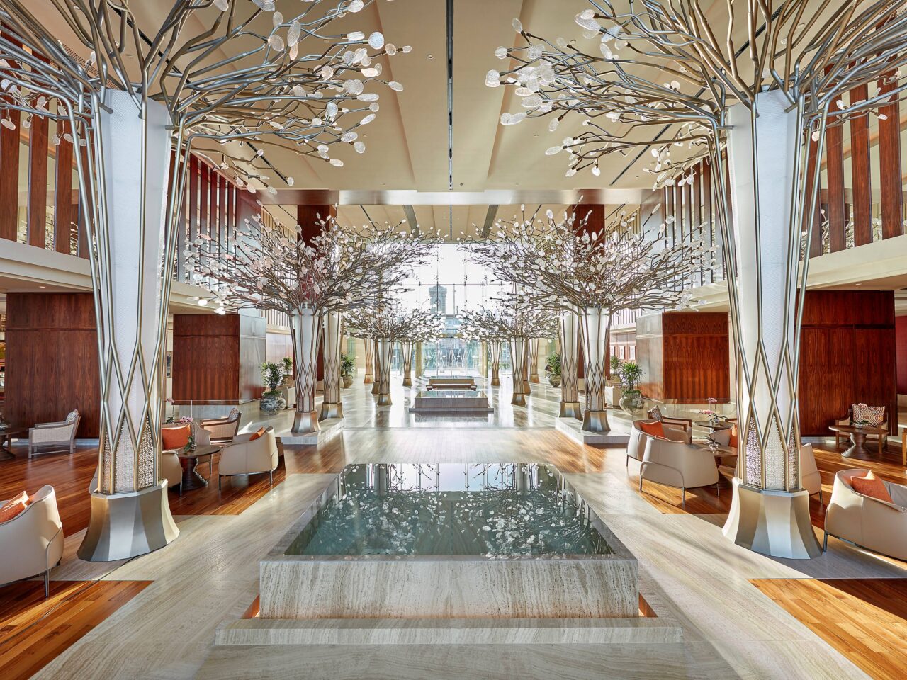 Grand Millennium Dubai lobby and pool area at Barsha Heights