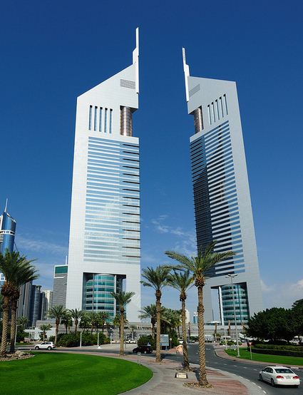Twin triangular Emirates Towers rising above Sheikh Zayed Road in Dubai