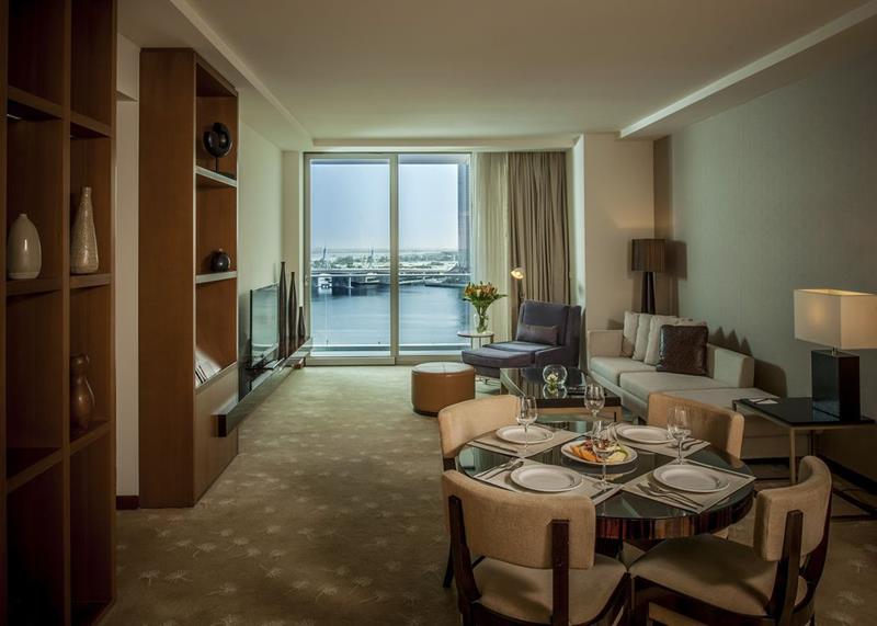 Living area of a residence suite overlooking the marina at Festival City