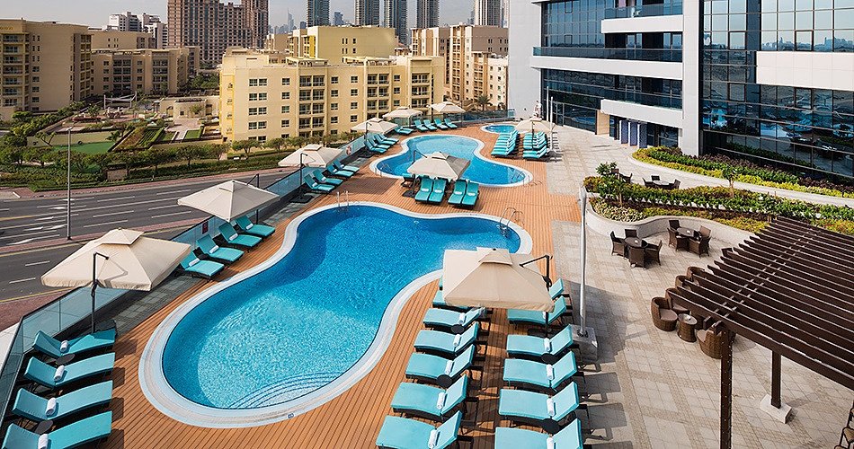 Millennium Place Barsha Heights pool deck with twin outdoor pools