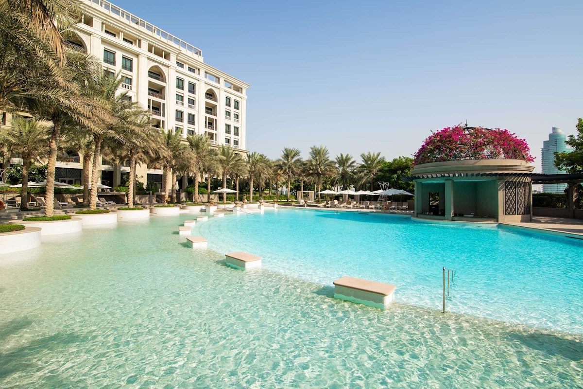 Palazzo Versace Dubai facade and landscaped gardens beside the Creek