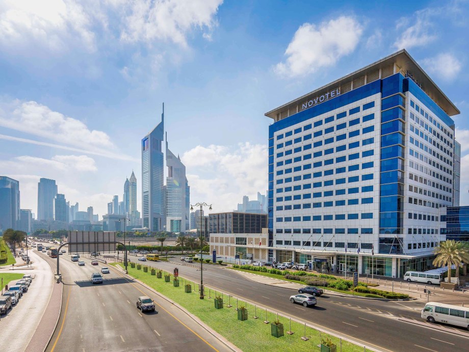 Novotel Dubai Al Barsha facade on Sheikh Zayed Road with city traffic below