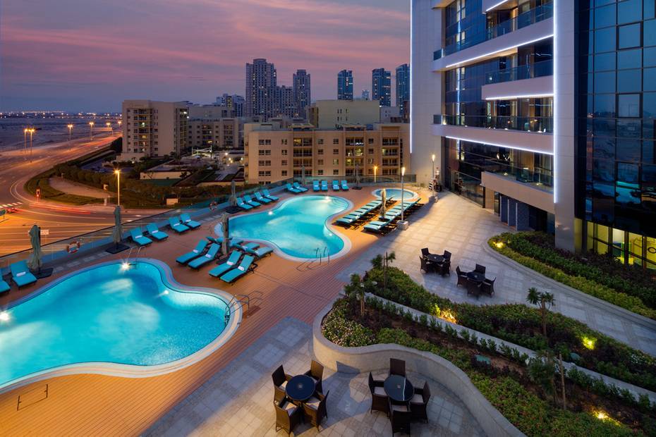 Millennium Place Barsha Heights hotel pool deck with twin pools