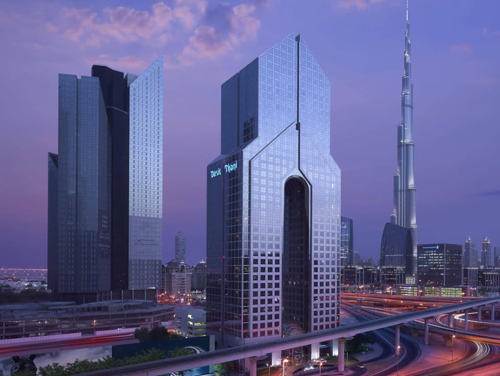 Distinctive tower of the Dusit Thani hotel on Sheikh Zayed Road at dusk