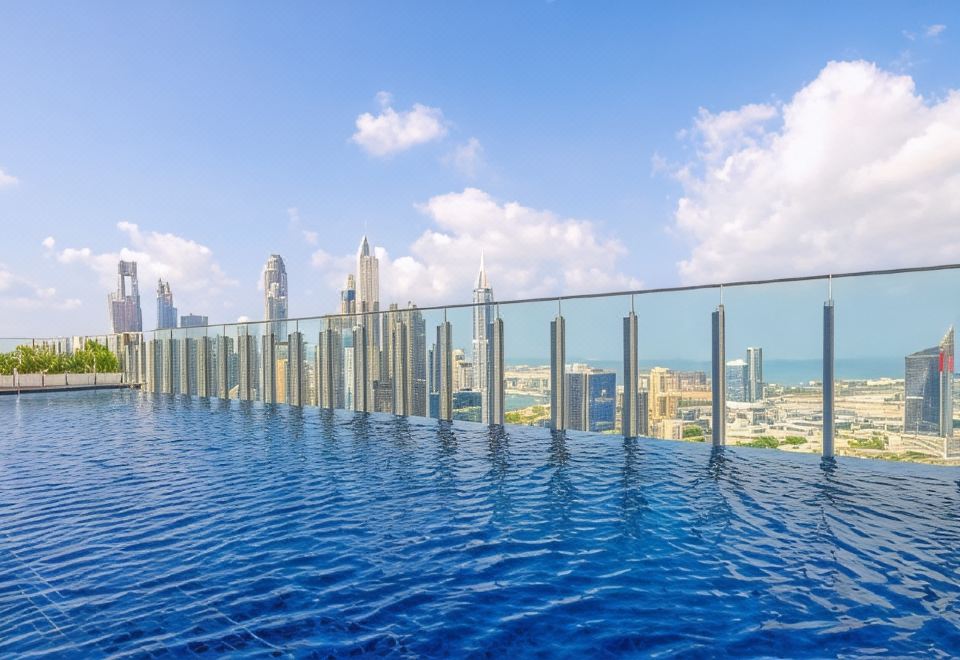 Taj Jumeirah Lakes Towers hotel and rooftop pool overlooking the JLT lakes