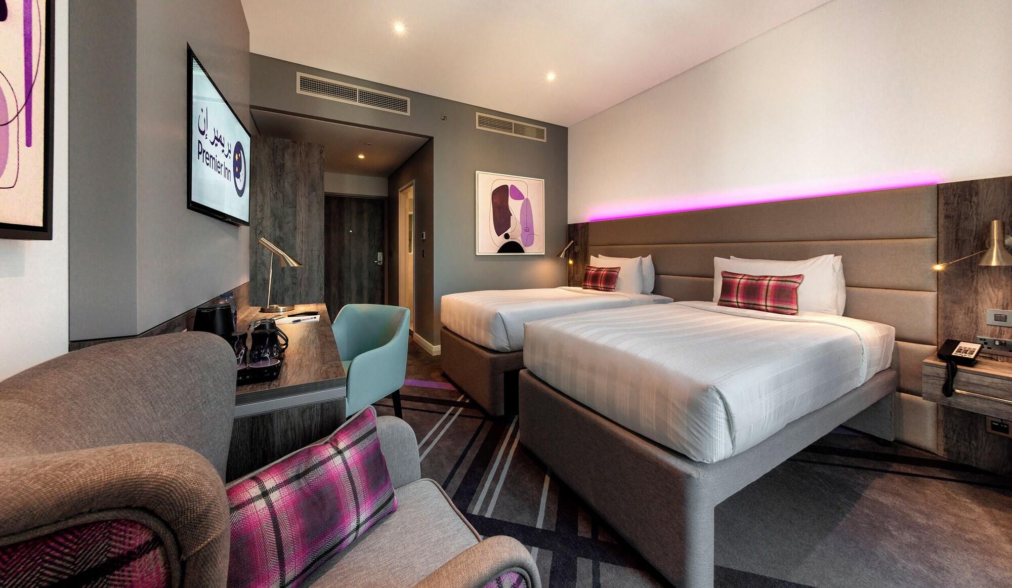 Premier Inn Dubai Barsha Heights family room with purple accents